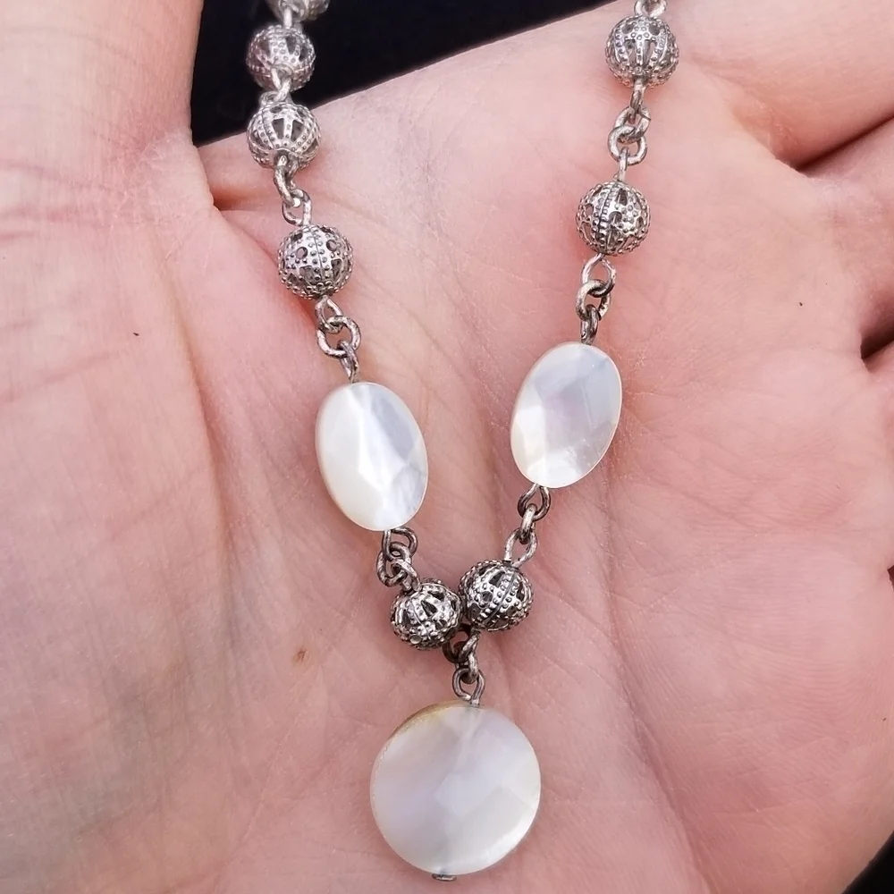 silver tone filigree ball necklace with white iridescent flat beads